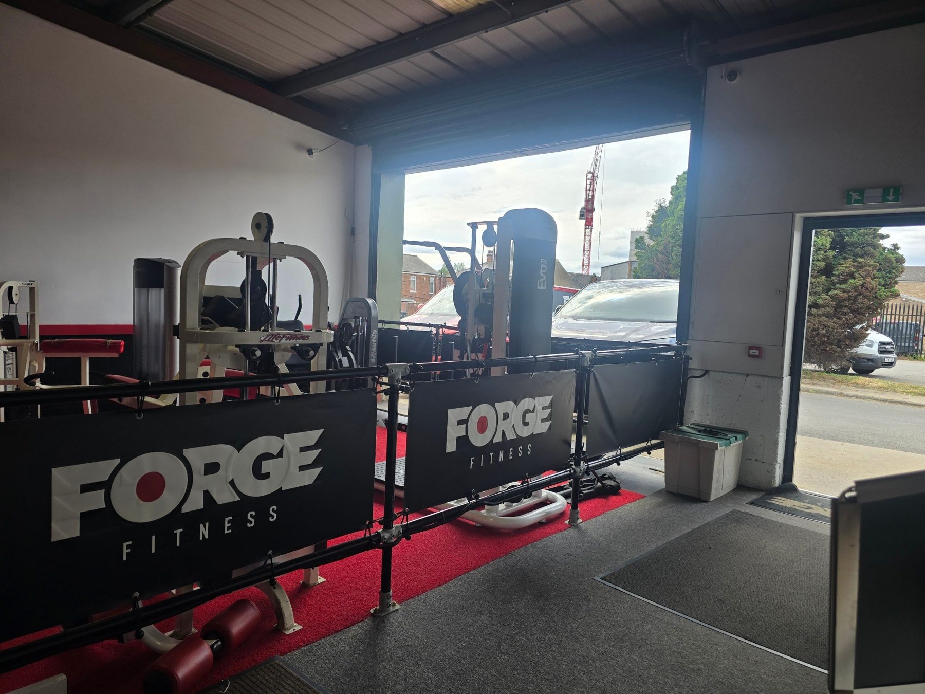 The FORGE branded wall and rig beside the window